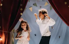 a boy and girl dancing on stage