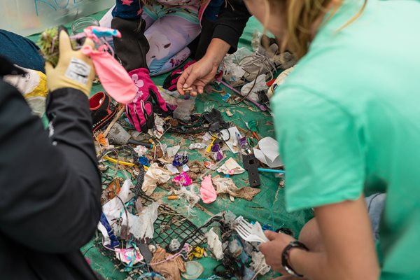 Community members sorting through plastics collected on the