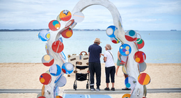a group of people standing on a beach