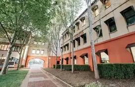 a building with trees and a walkway
