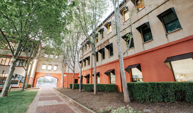 a building with trees and a walkway