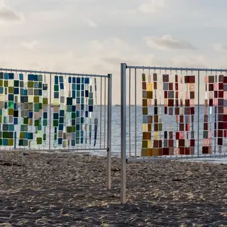 a fence with colorful squares on it