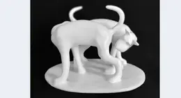a white statue of two cats