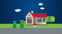 a house with a red roof and two trash cans