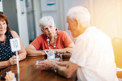 Seniors around a table at a cafe