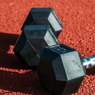 a pair of weights on a red surface