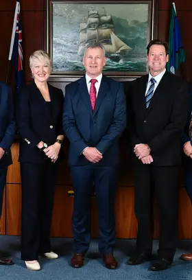 a group of people in suits