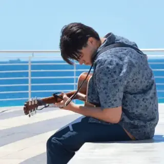 A young musician playing guitar at The Lookout, Rockingham Foreshore