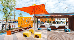 a bench and umbrella on a sidewalk