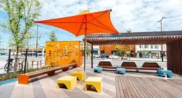 a bench and umbrella on a sidewalk