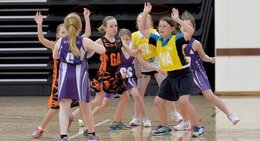 a group of young girls playing basketball