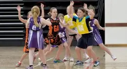 a group of young girls playing basketball