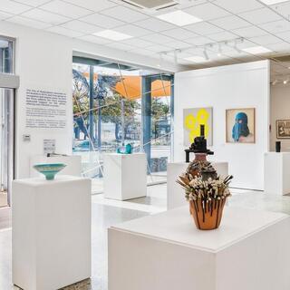 Installation view of the 2025 Art Prize featuring a mix of paintings, sculptures on plinths and hanging artworks.