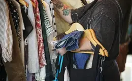 a person holding clothes on swingers