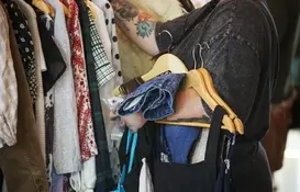 a person holding clothes on swingers