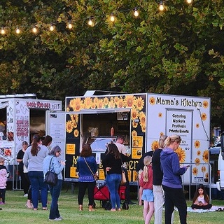 a group of people standing in a field
