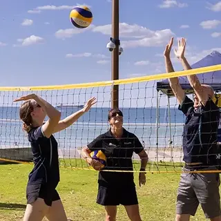 a group of people playing volleyball