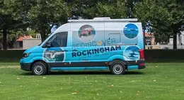 a blue van with a blue and black logo on it