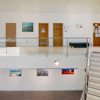 a room with a glass railing and doors