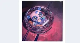 a toy in a glass ashtray
