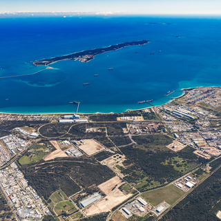 Aerial view of the Rockingham Industrial Zone with coastal waters, port facilities, roads and surrounding land.