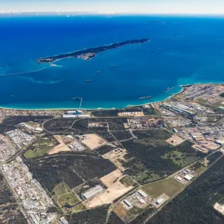 Aerial view of the Rockingham Industrial Zone with coastal waters, port facilities, roads and surrounding land.
