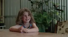 a girl sitting at a table