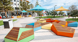 a colorful benches and umbrellas in a park