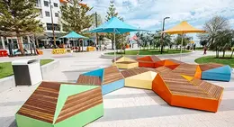 a colorful benches and umbrellas in a park