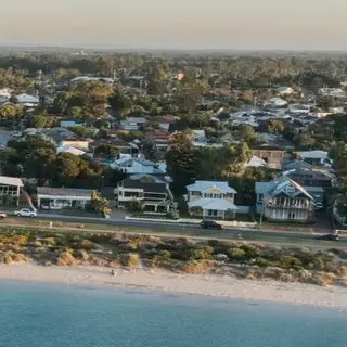 a beach with buildings and a body of water