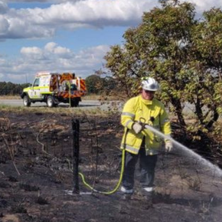 a group of men standing near a fence