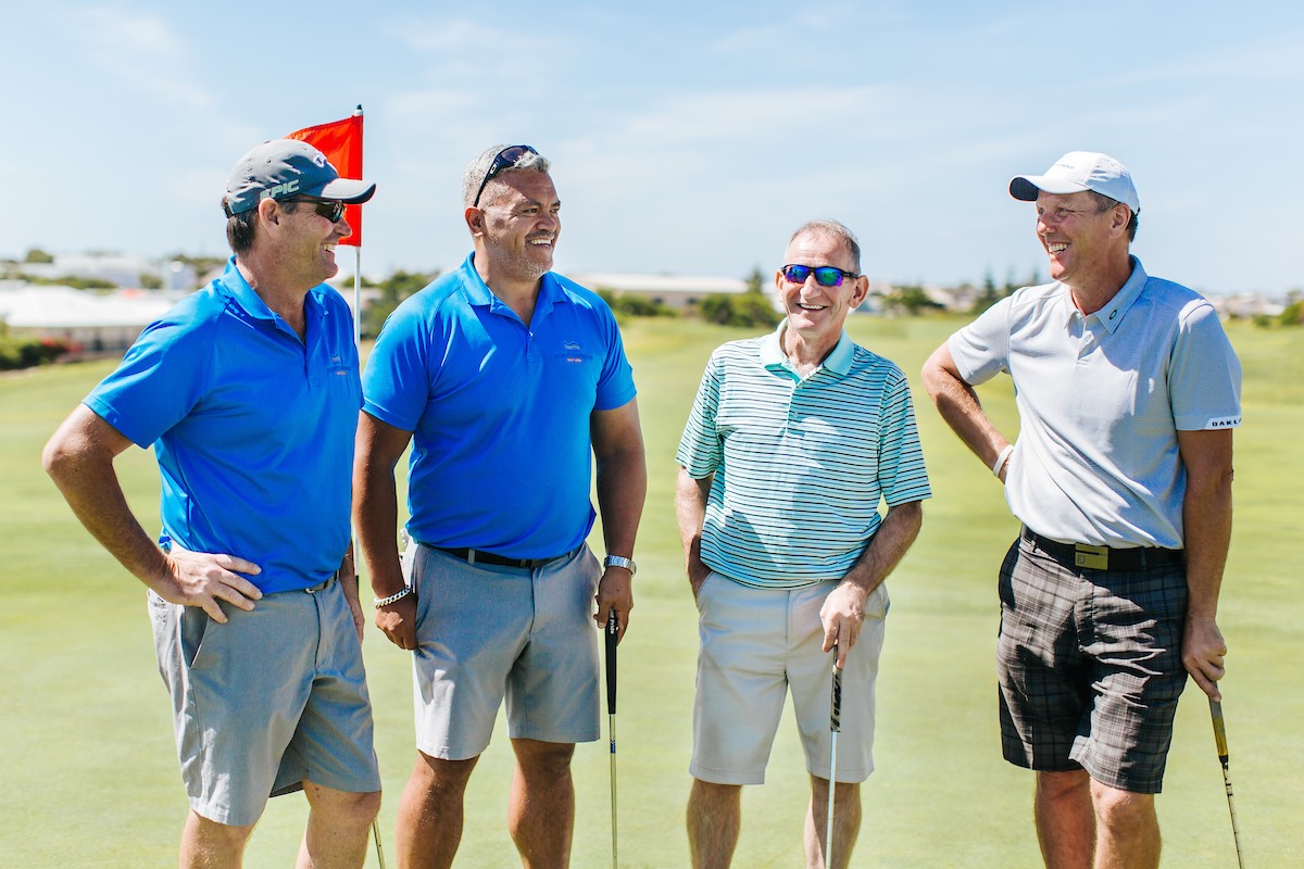 Four men out on the golf course.