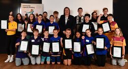 a group of people holding certificates